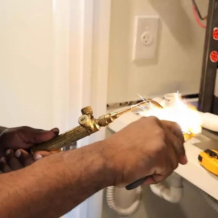 A technician brazing copper line set