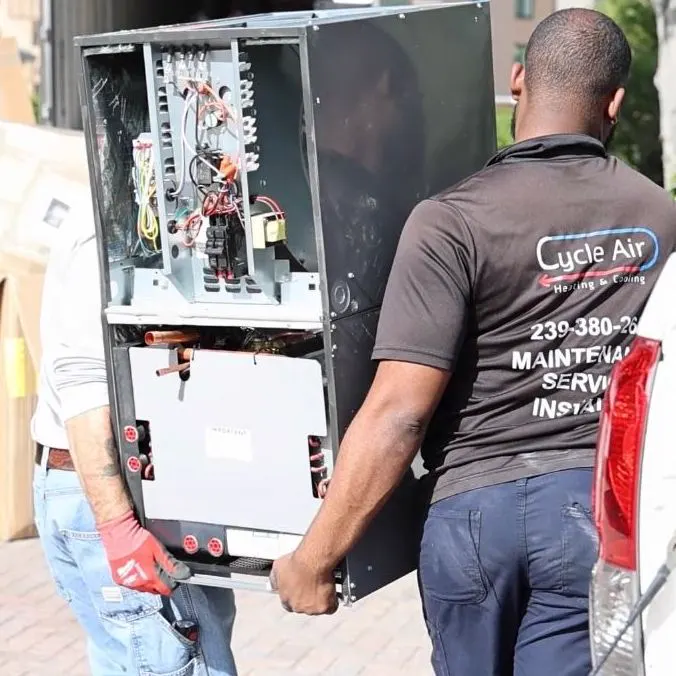 Two Cycle Air technicians carrying an air handler