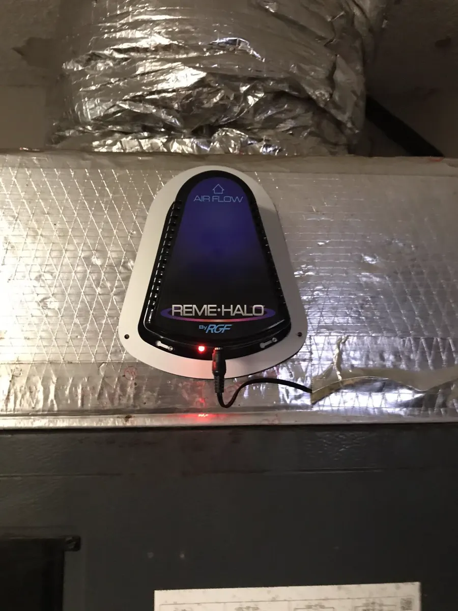 An in-duct air purifier installed above the coil