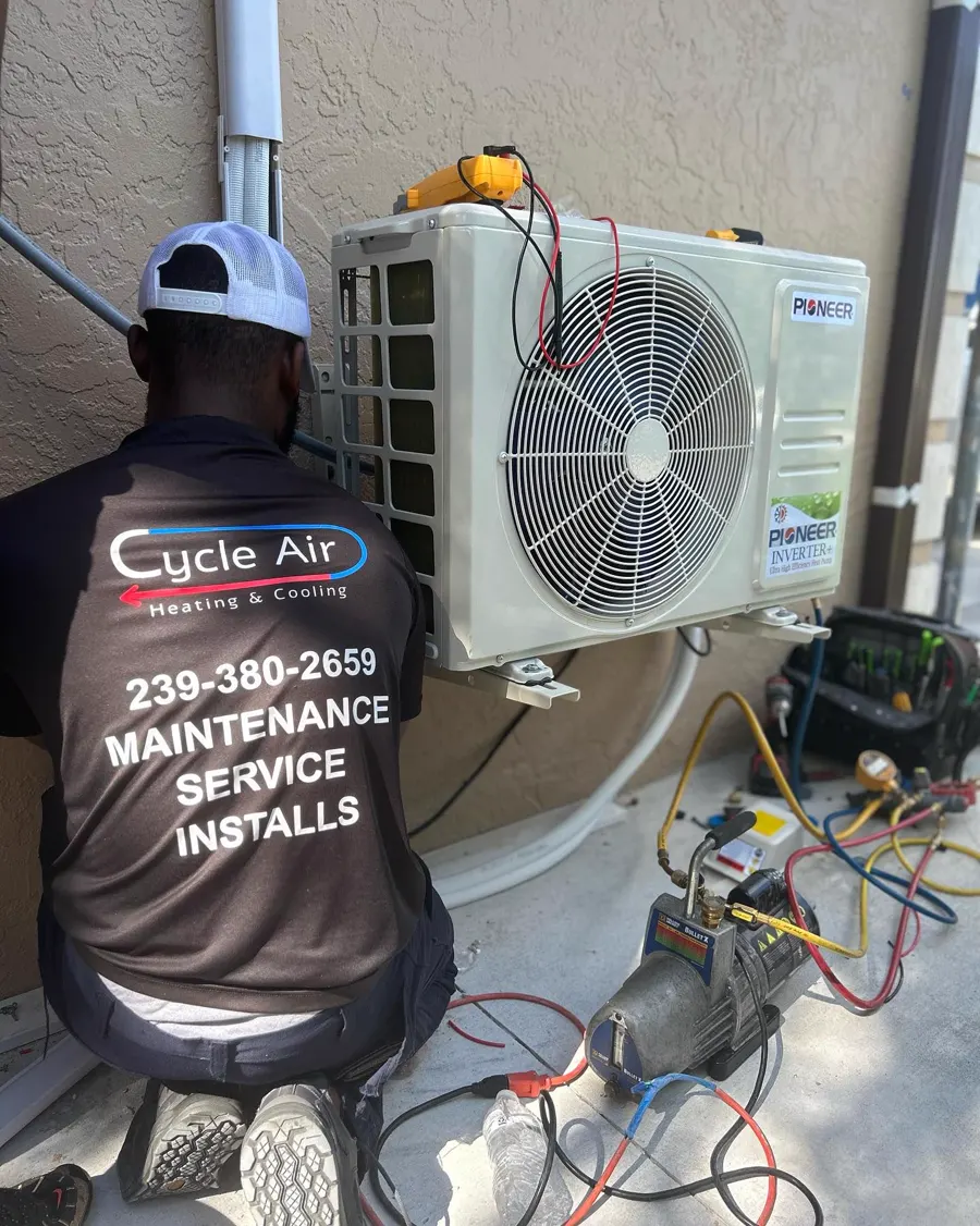 A Cycle Air technician servicing a mini split outdoor unit